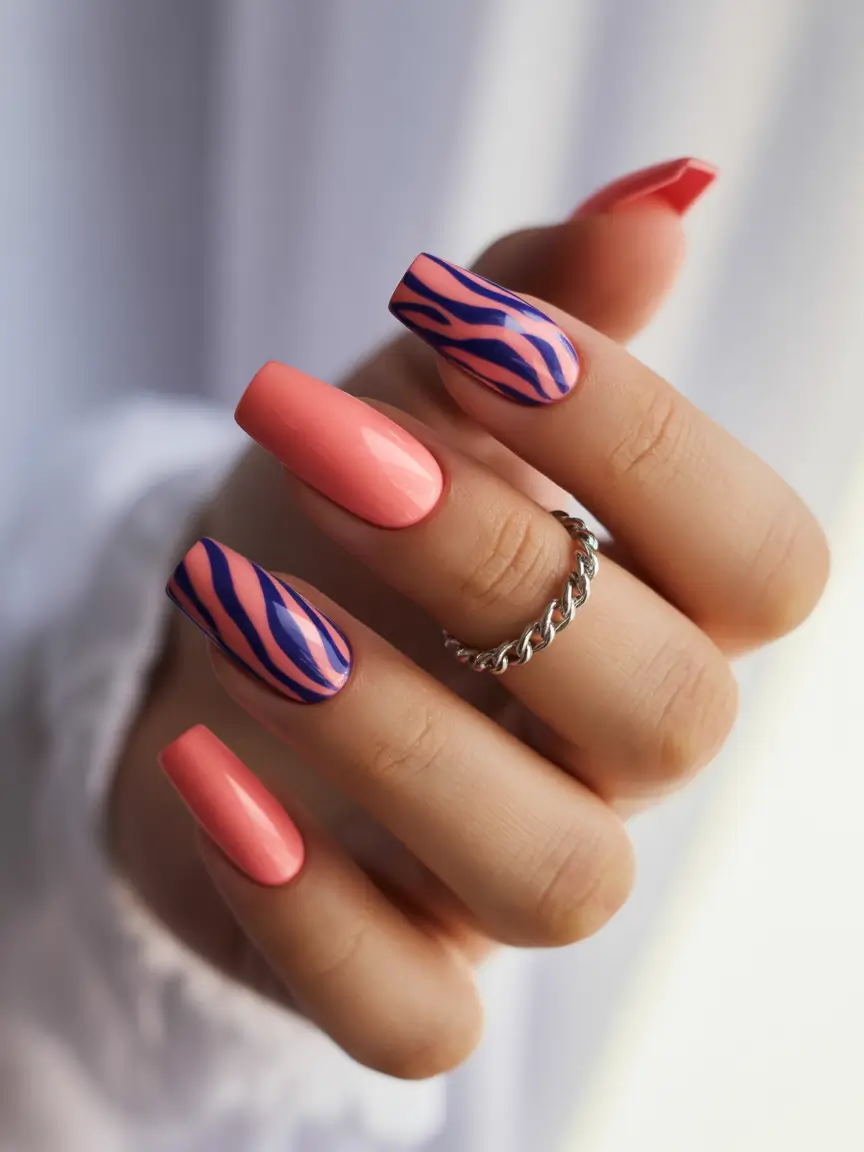 Colorful Summer Nails to Try in 2025 Bold Coral Meets Blue Tiger Stripe