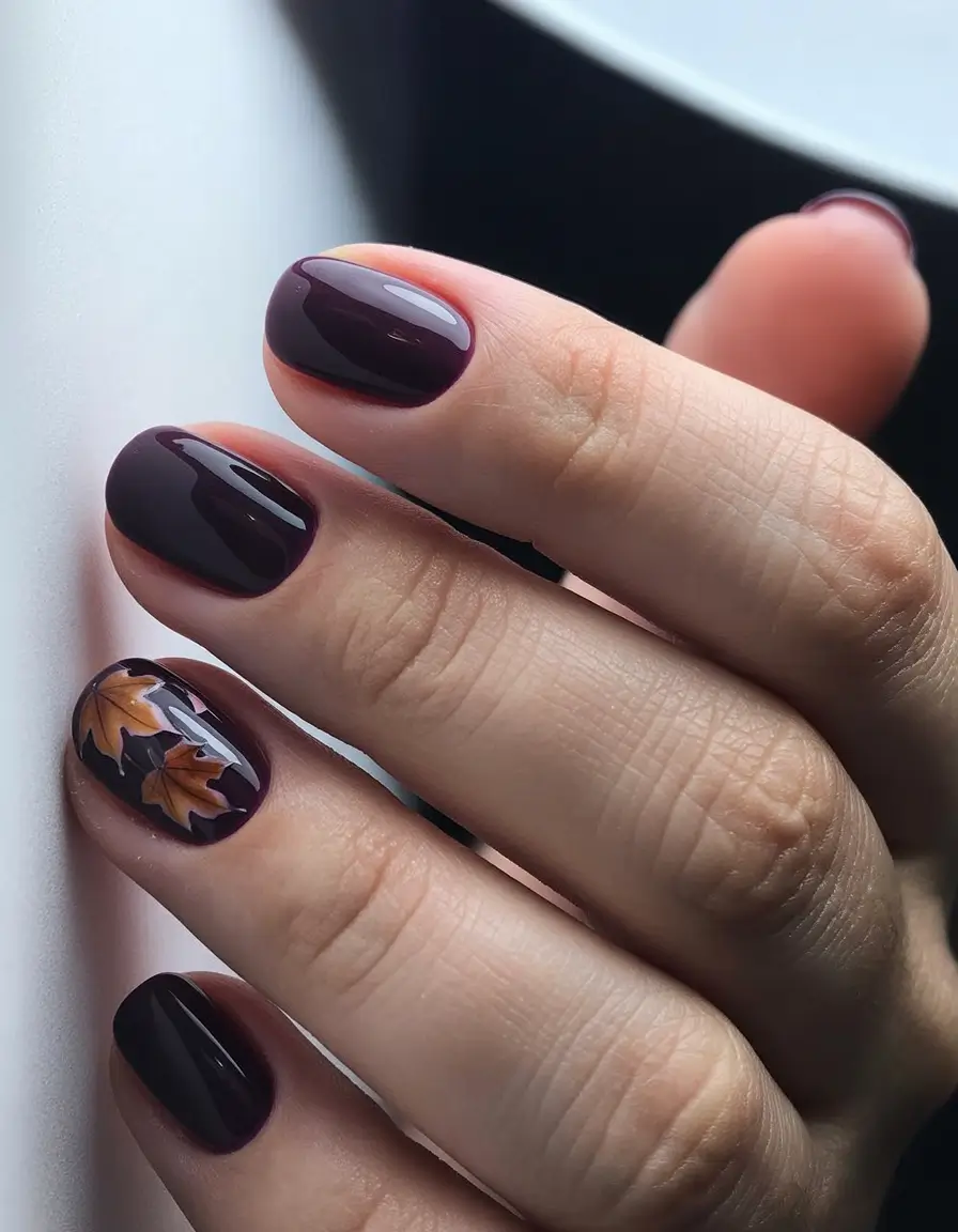 autumn nails designs 2025 deep plum with leaf accent