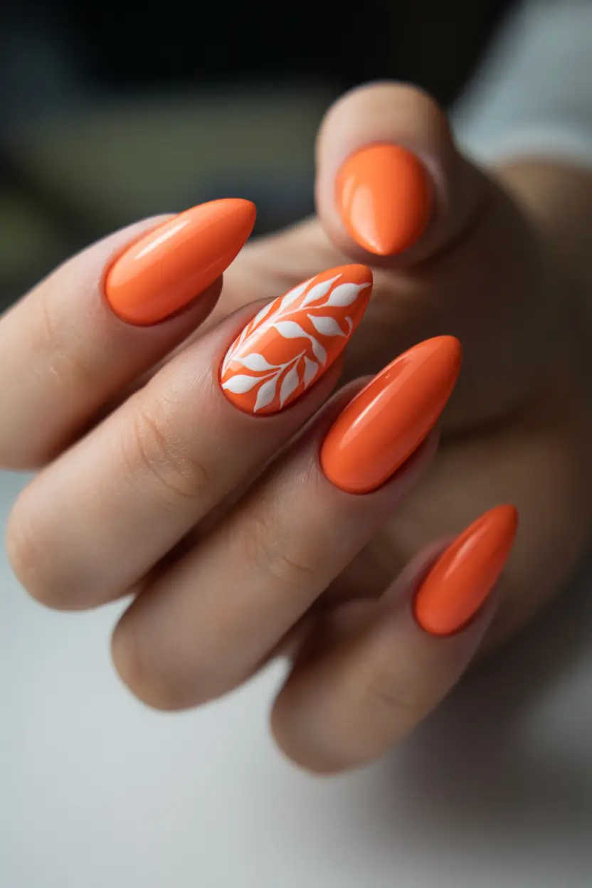 early fall nails ideas 2025 Vivid Pumpkin with White Leaf Accent