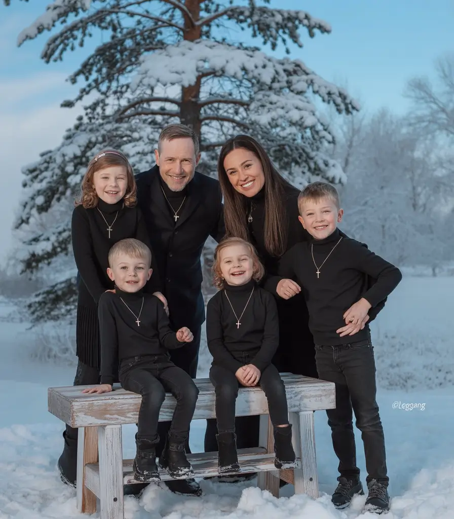winter family photo outfits 2025-2026 Monochrome Black Elegance in the Snow