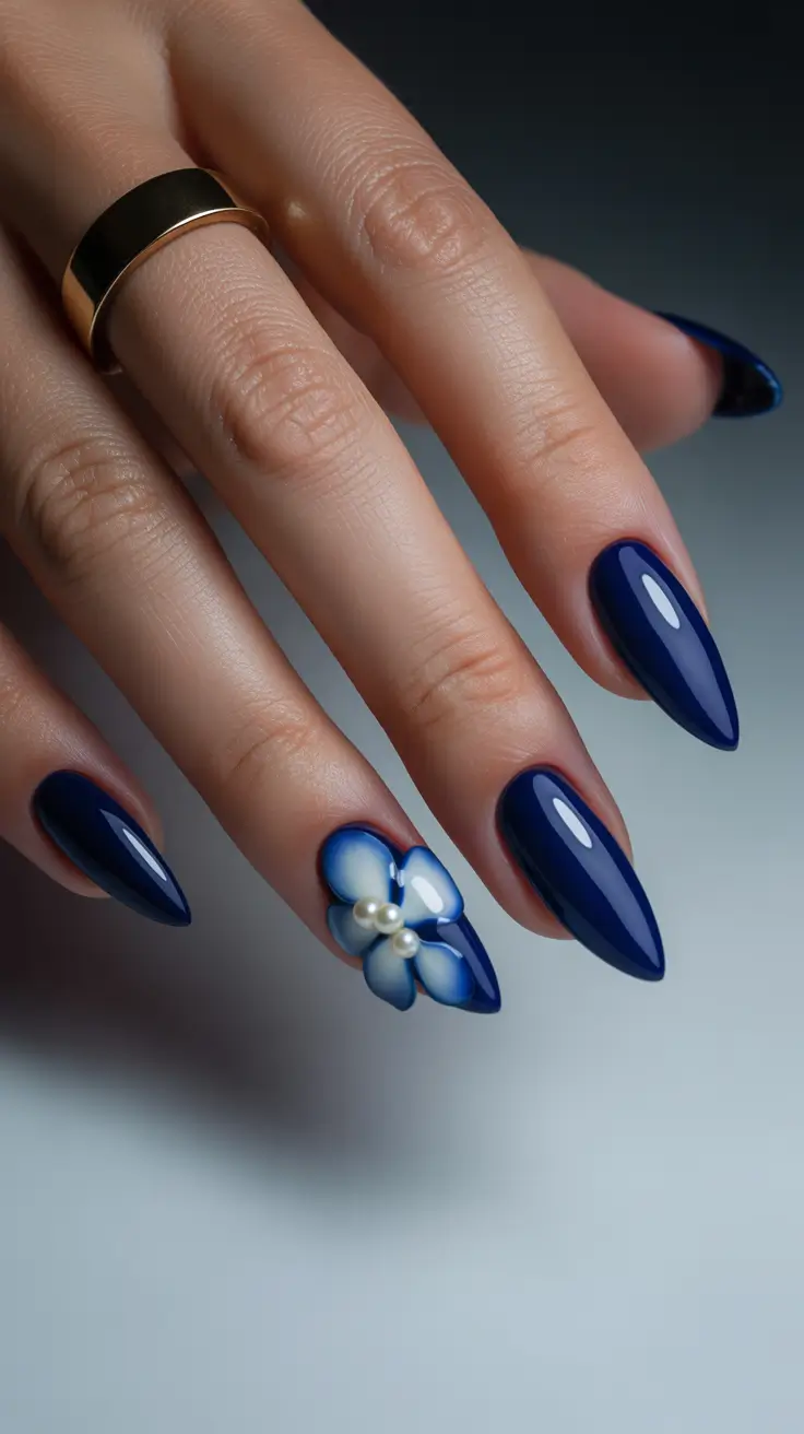 birthday nails 2026 Deep Blue Almond Nails with Floral Accent