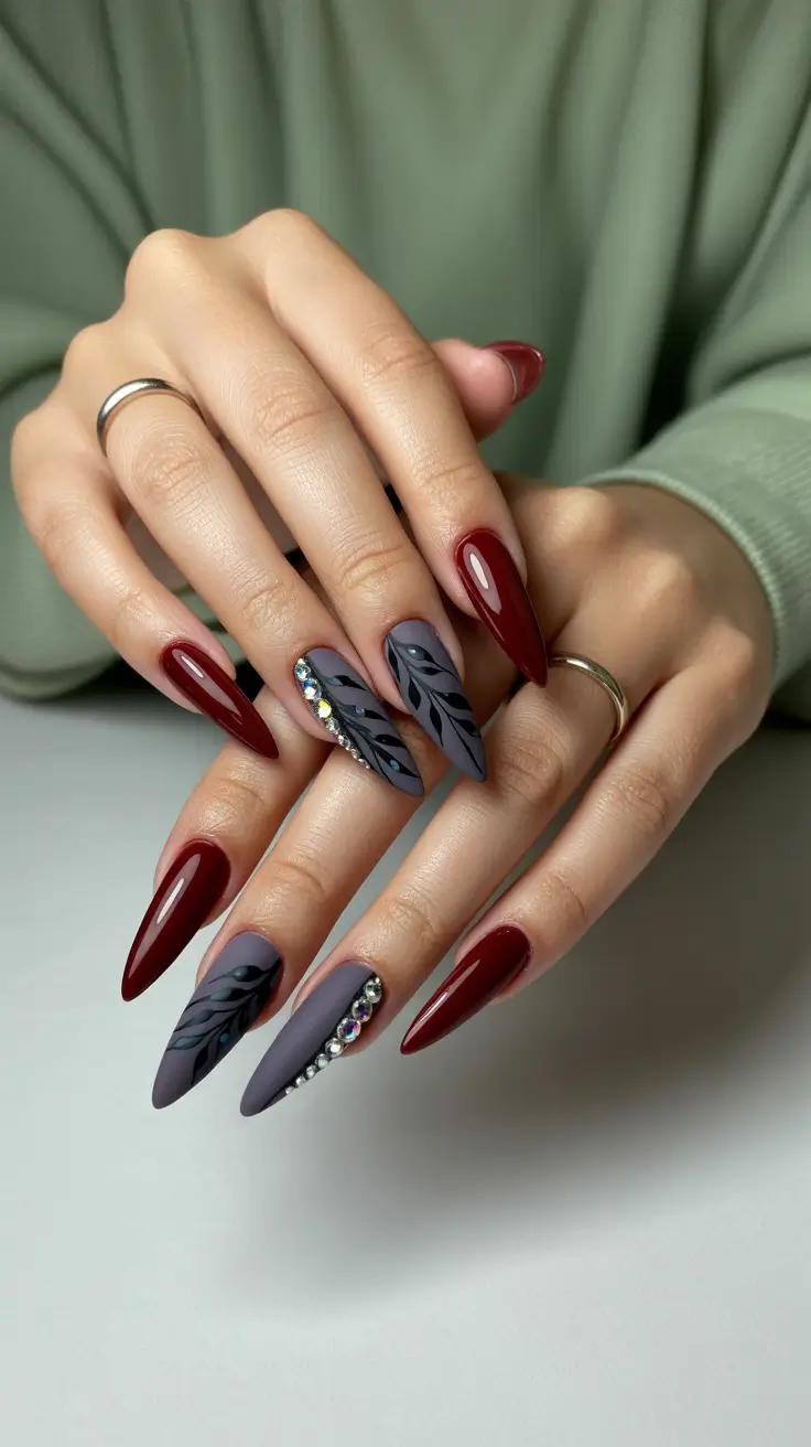 February Nails Designs 2026 Burgundy And Smoky Gray Stilettos With Crystal Detail