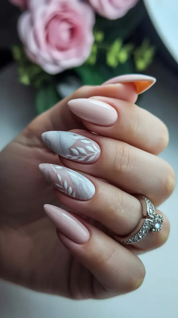 graduation nails ideas 2026 Soft Pink Almond Nails with Botanical White Art