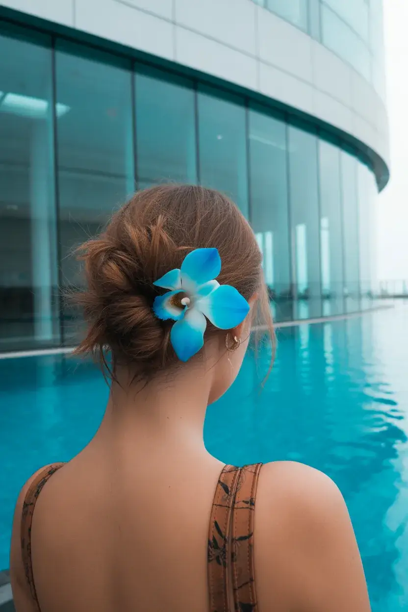 summer hairstyles for swimming 2026 Loose Low Bun with Soft Volume and Floral Clip