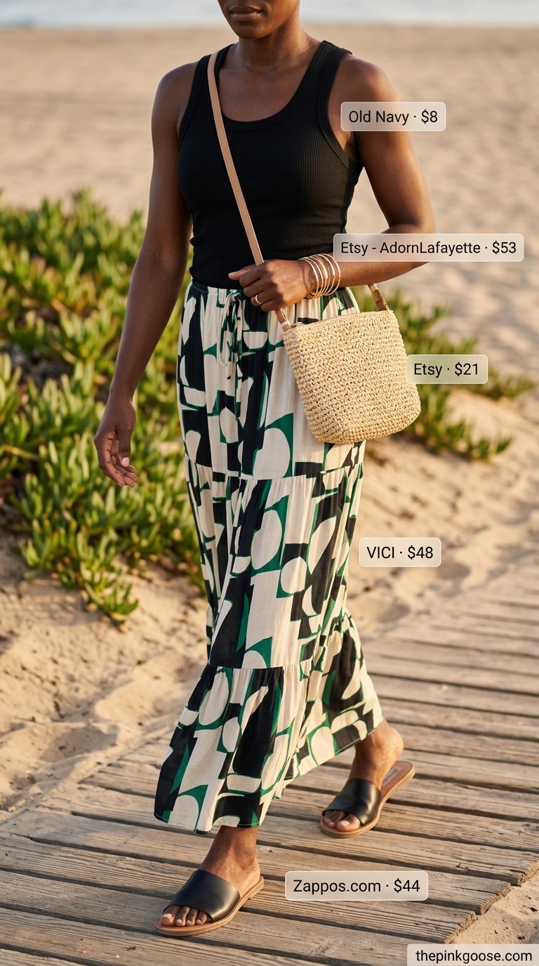 Bold summer outfits for black woman 2026: Artistic maxi skirt with black ribbed tank, straw bag, and gold bangles.