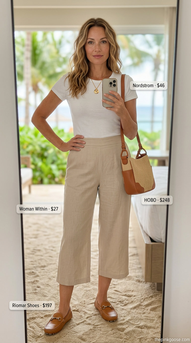Hamptons summer old money outfit 2026: Beige linen capri pants with a soft blue blouse, gold necklace, and tan loafers.