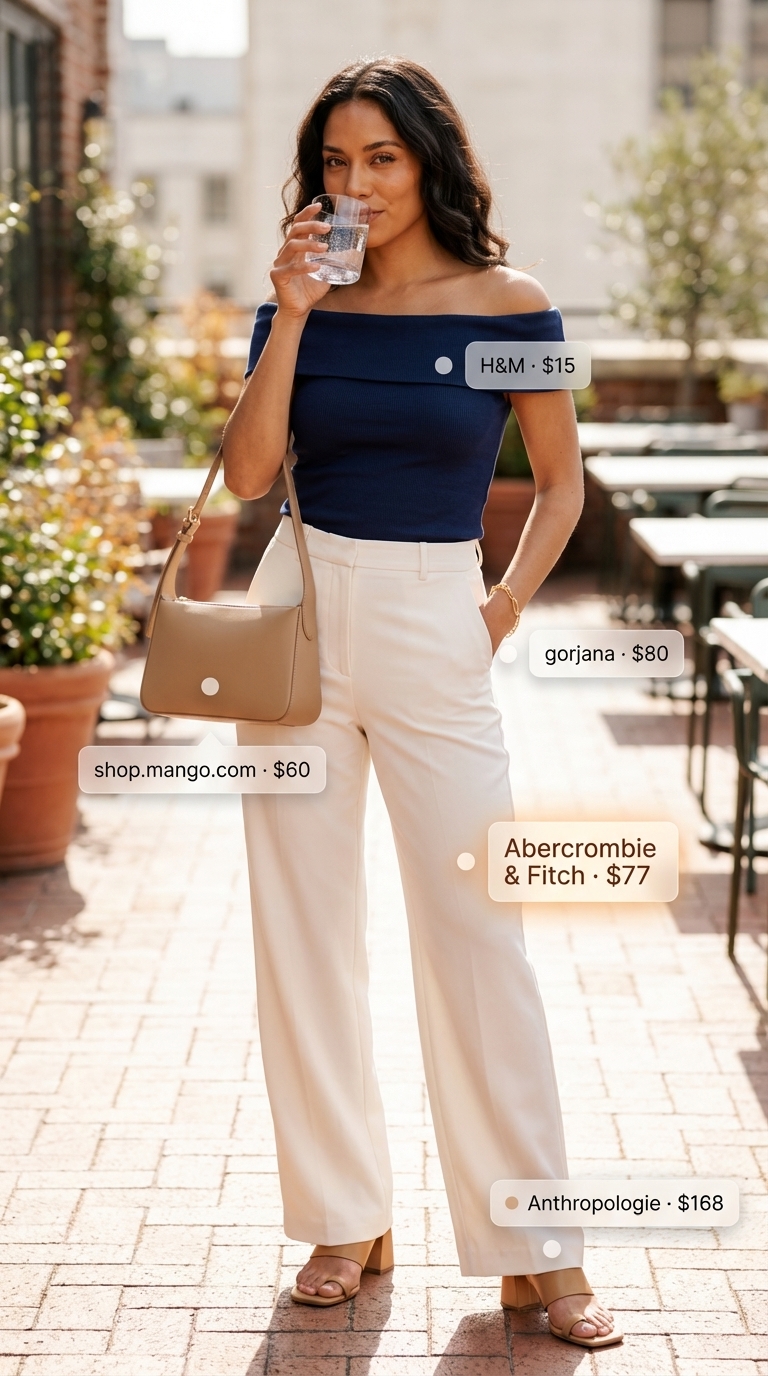 Sophisticated navy blue off-shoulder ribbed knit top with cream wide-leg trousers, a modern style for summer off-shoulder outfits for women 2026. Completed with tan mules and a structured shoulder bag for city brunch.