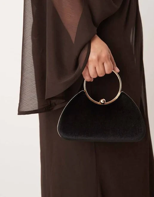 True Decadence velvet clutch bag with detachable crossbody strap in black and gold