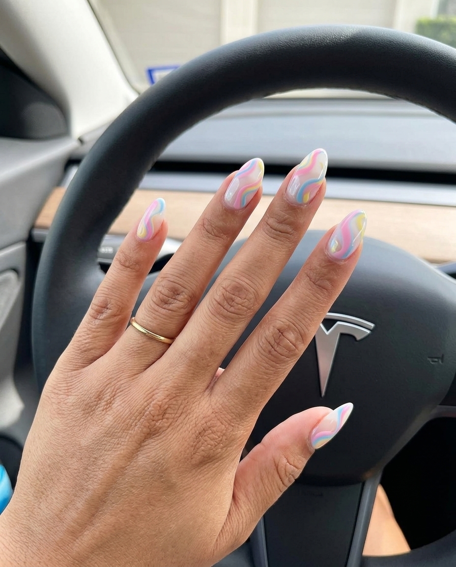 Abstract pastel swirls on sheer white almond nails for summer 2026 whimsical style.