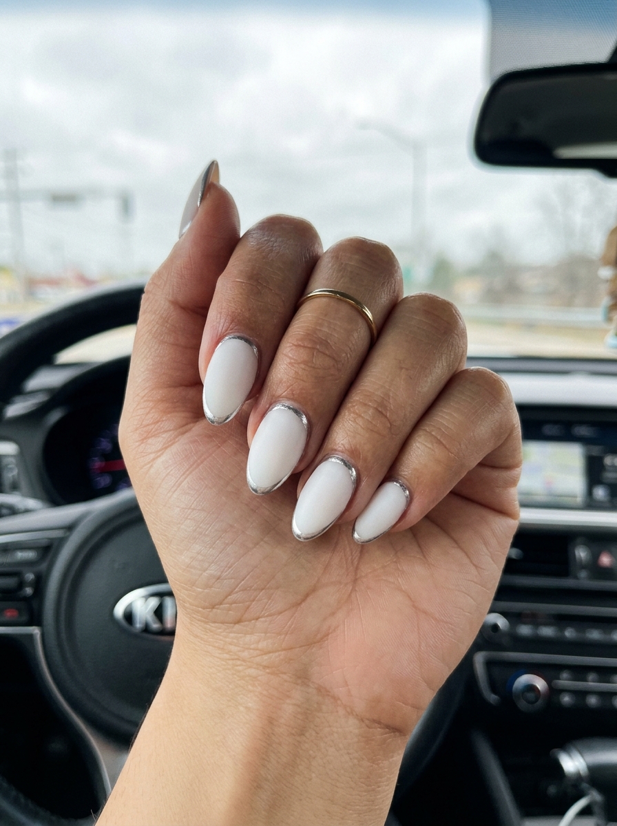 Milky White Chrome Line Almond Nails Summer 2026 Milky white almond nails with subtle silver chrome line for summer 2026 minimalist chic.