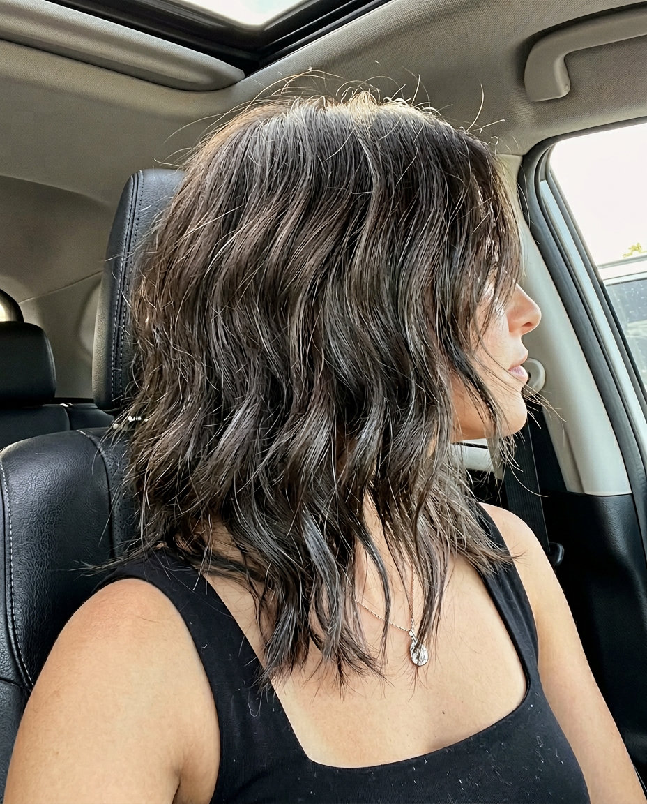 medium-length textured shag haircut in deep espresso with charcoal lowlights for round face
