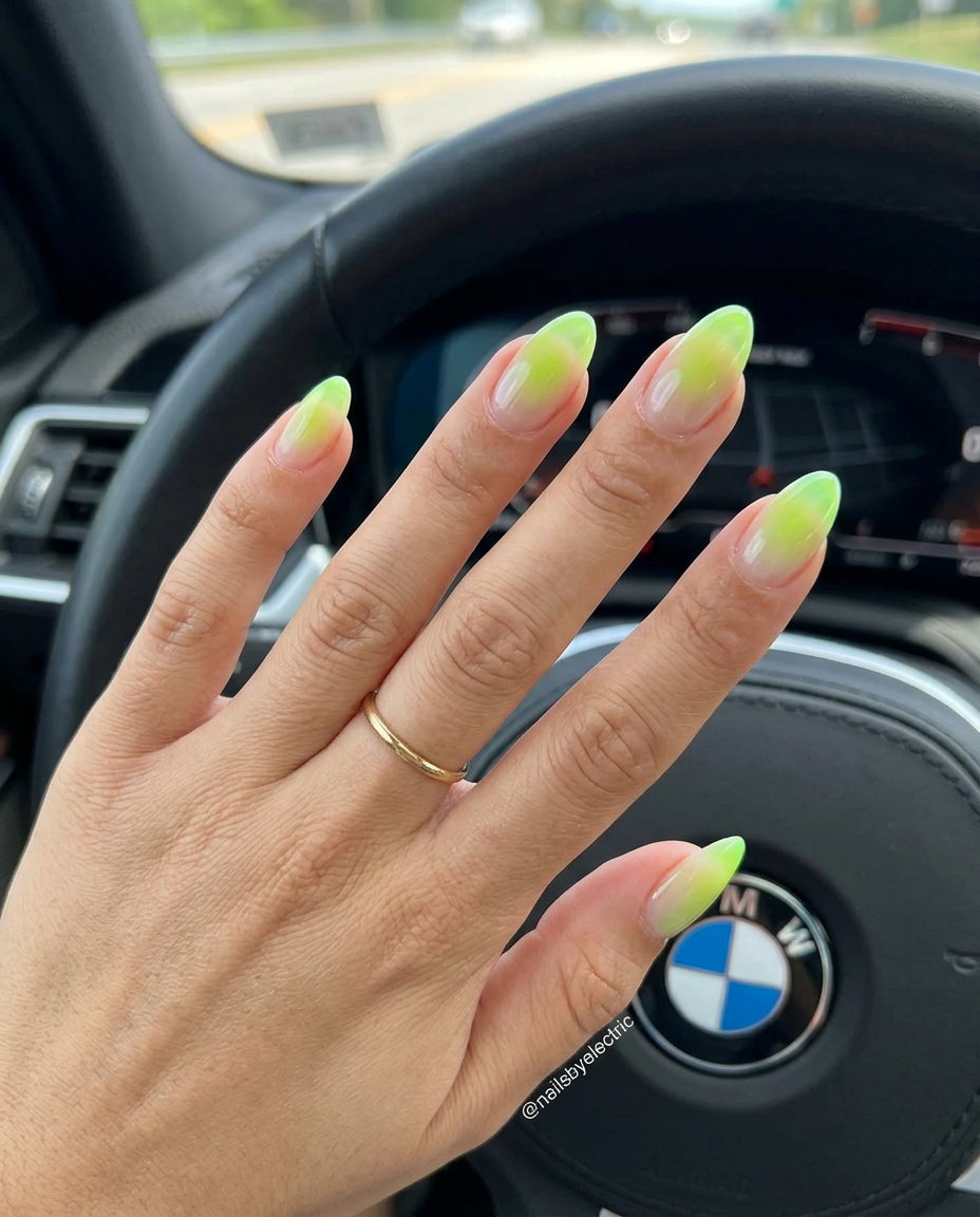 Electric lime aura nails with a clear base for a futuristic vibe. Neon summer nails 2026.