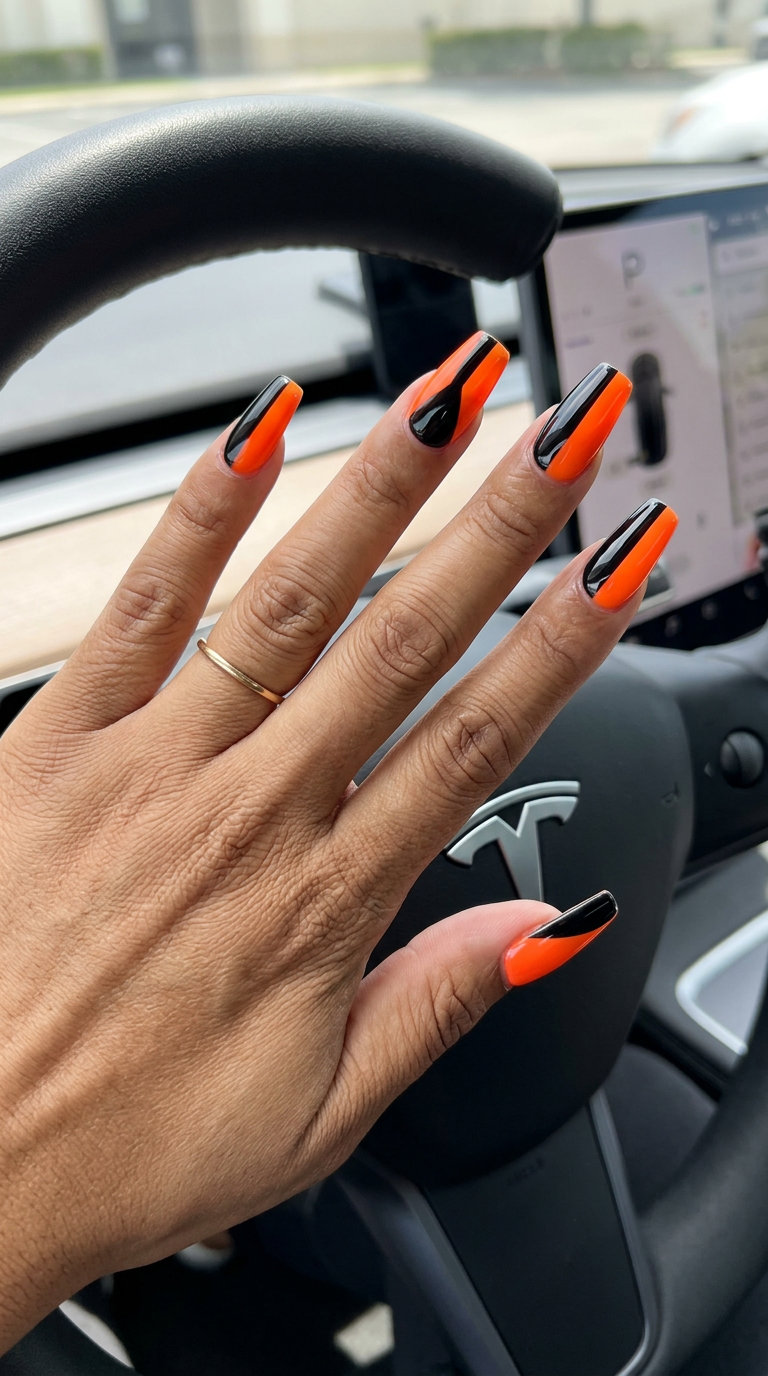 Neon orange and black color block coffin nails for neon summer nails 2026, ideal for nights out and concerts.