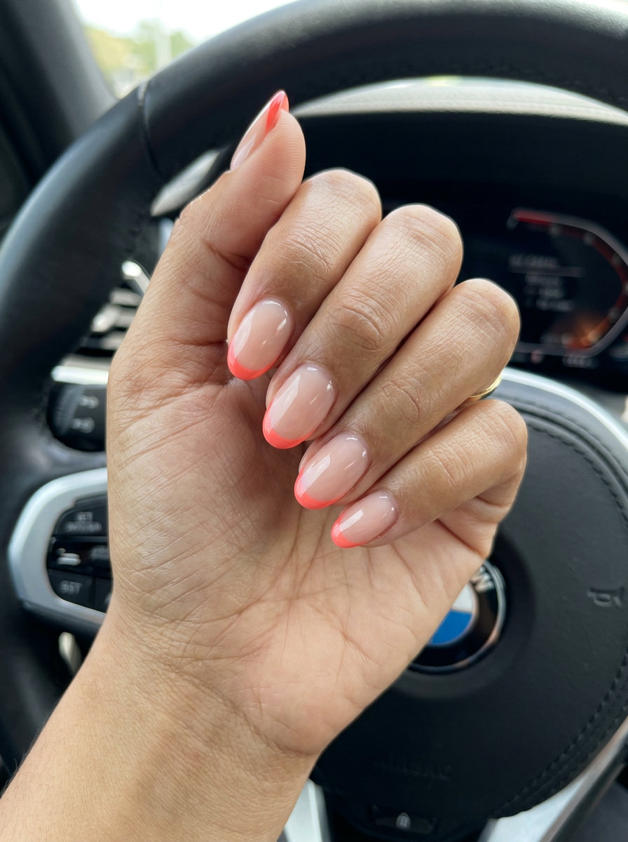 Sunset coral micro French oval summer nails 2026 for all skin tones, vibrant and playful vacation style.