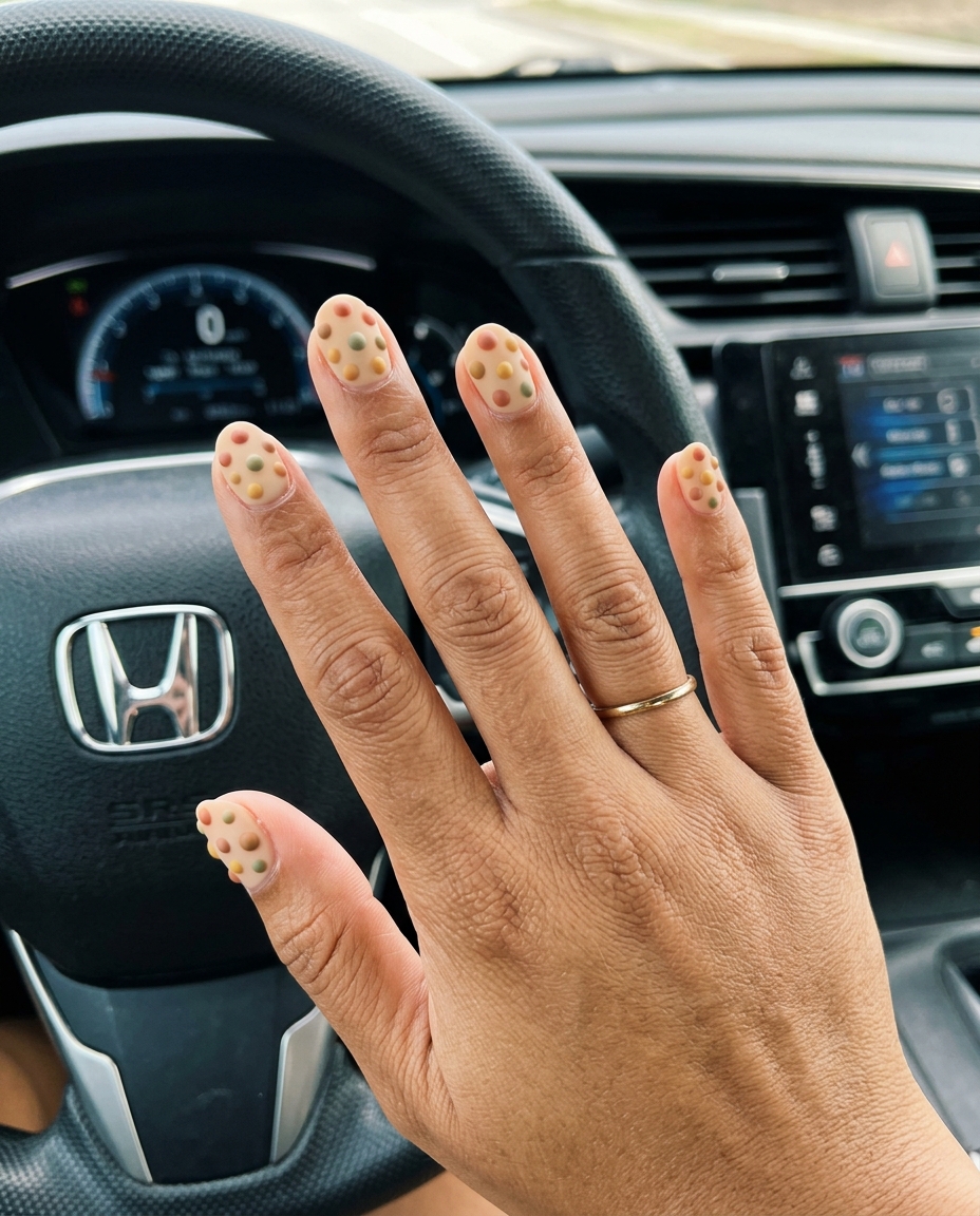 Textured earth tone rainbow dots nails 2026 on short round nails for a bohemian style.