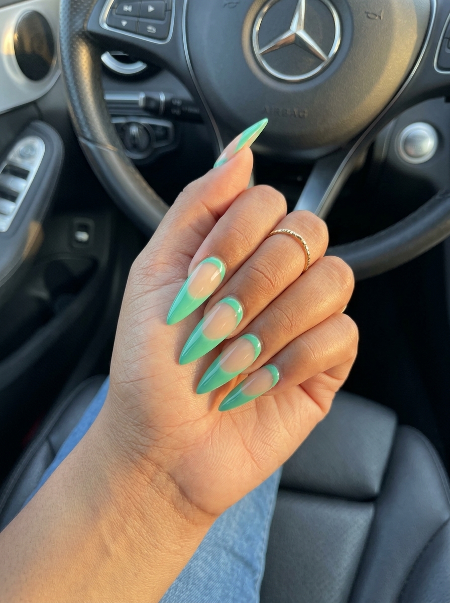 Seafoam Stiletto Reverse French nails for simple vacation nails 2026, edgy and bold with seafoam green.