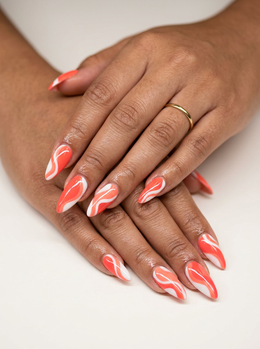 Bold stiletto summer nails 2026 in vibrant coral abstract art for festivals.