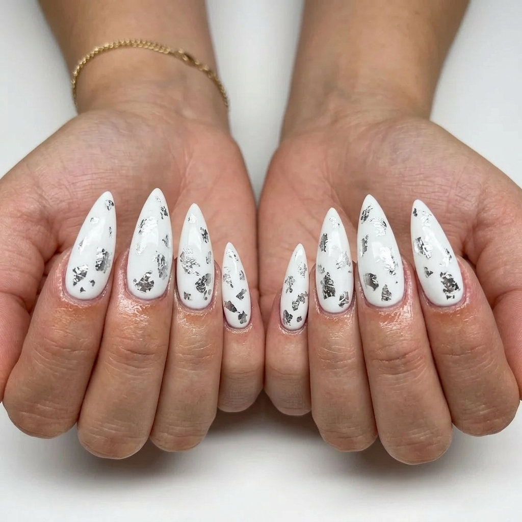 Edgy white stiletto nails with silver foil accents for festival and summer parties. Stiletto summer nails 2026.