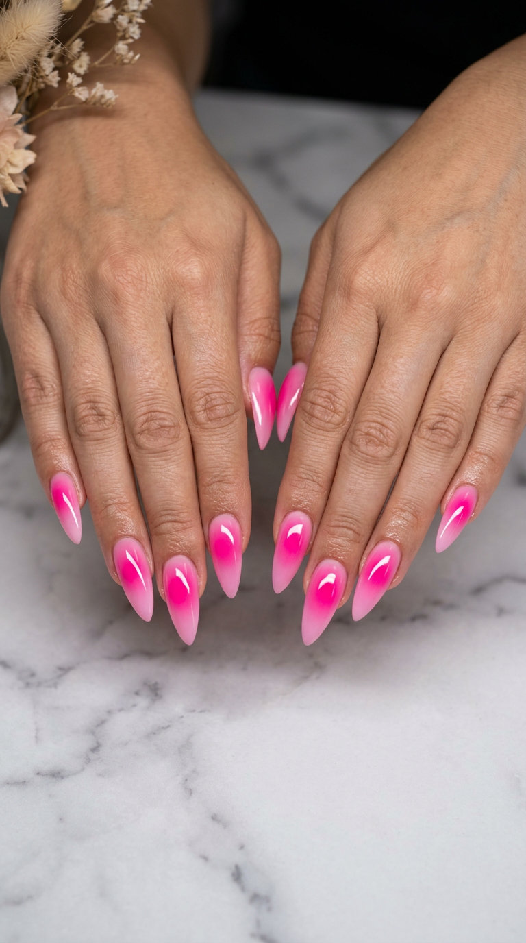 Energetic stiletto summer nails 2026 in hot pink aura gradient for concerts.