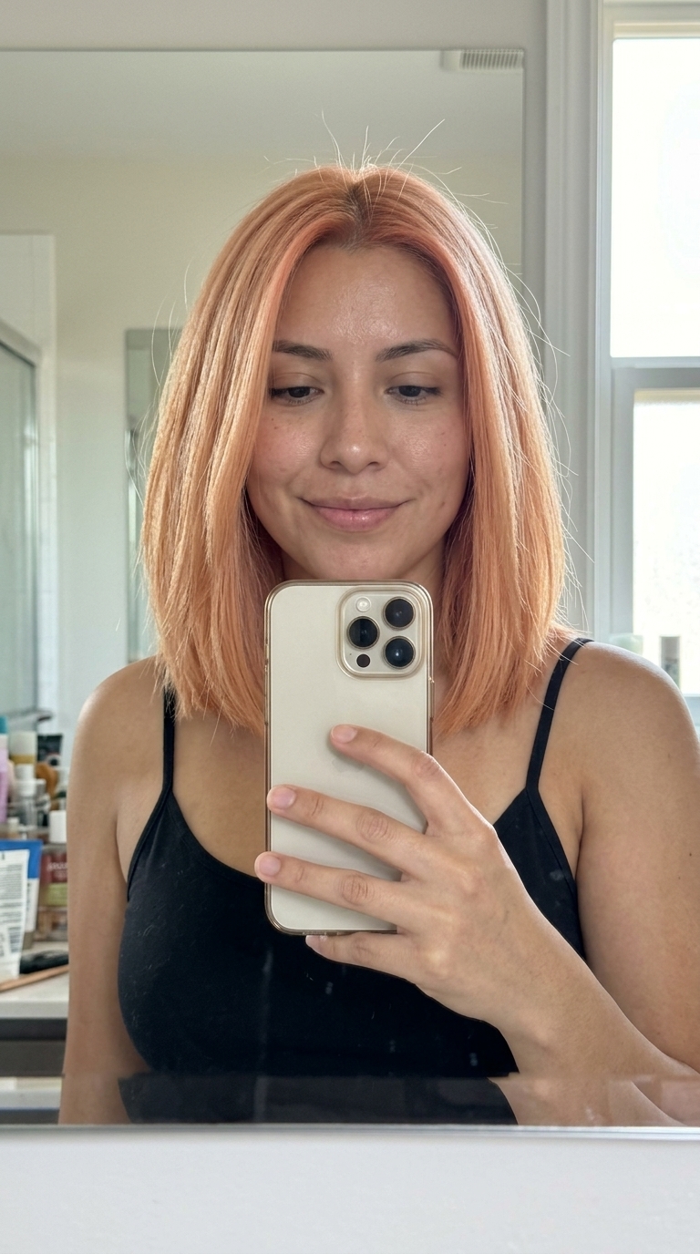 shoulder-length blunt lob in creamy strawberry blonde with peach undertones, sleek finish, no bangs — professional and modern