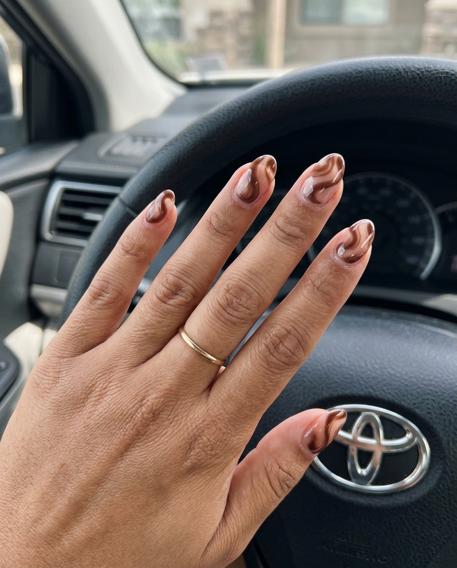 Elegant Chocolate Swirl Nails 2026 Sheer chocolate swirl medium oval acrylic nails with clear base for sophisticated summer acrylic oval nails 2026.