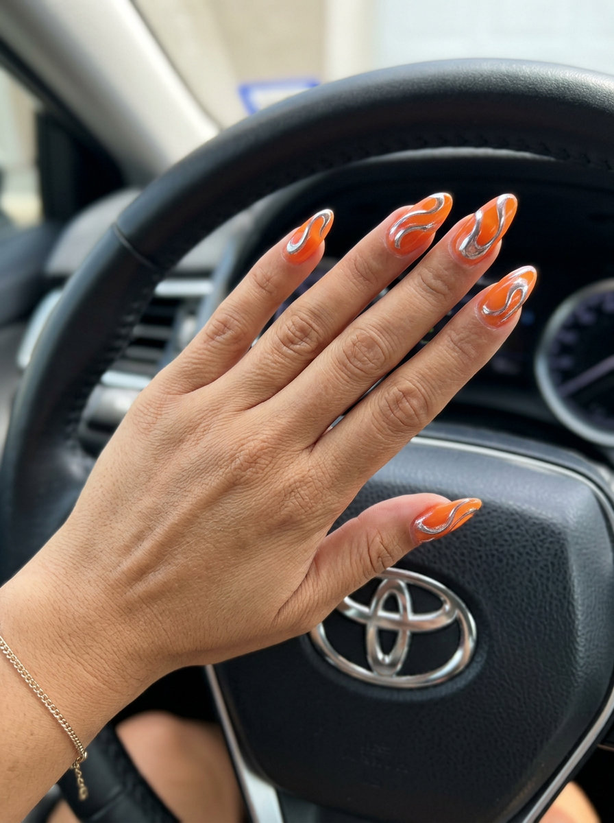 Tangerine Swirl Chrome Almond Nails - Summer Citrus Nail Art 2026 Tangerine Swirl Chrome Almond nails for summer citrus nail art 2026. Glamorous orange and silver chrome for parties.