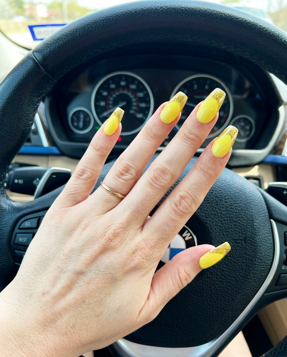 Yellow Summer Nails 2026: Glitter French Party Glamorous lemon yellow nails with chunky gold glitter French tips for parties in summer 2026.