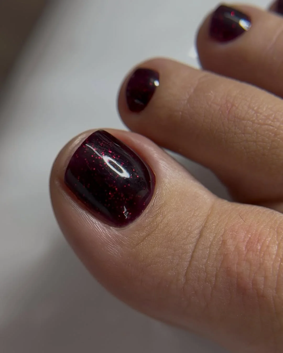 june pedicure ideas 2026 Cherry Cola Sparkle for Warm June Evenings