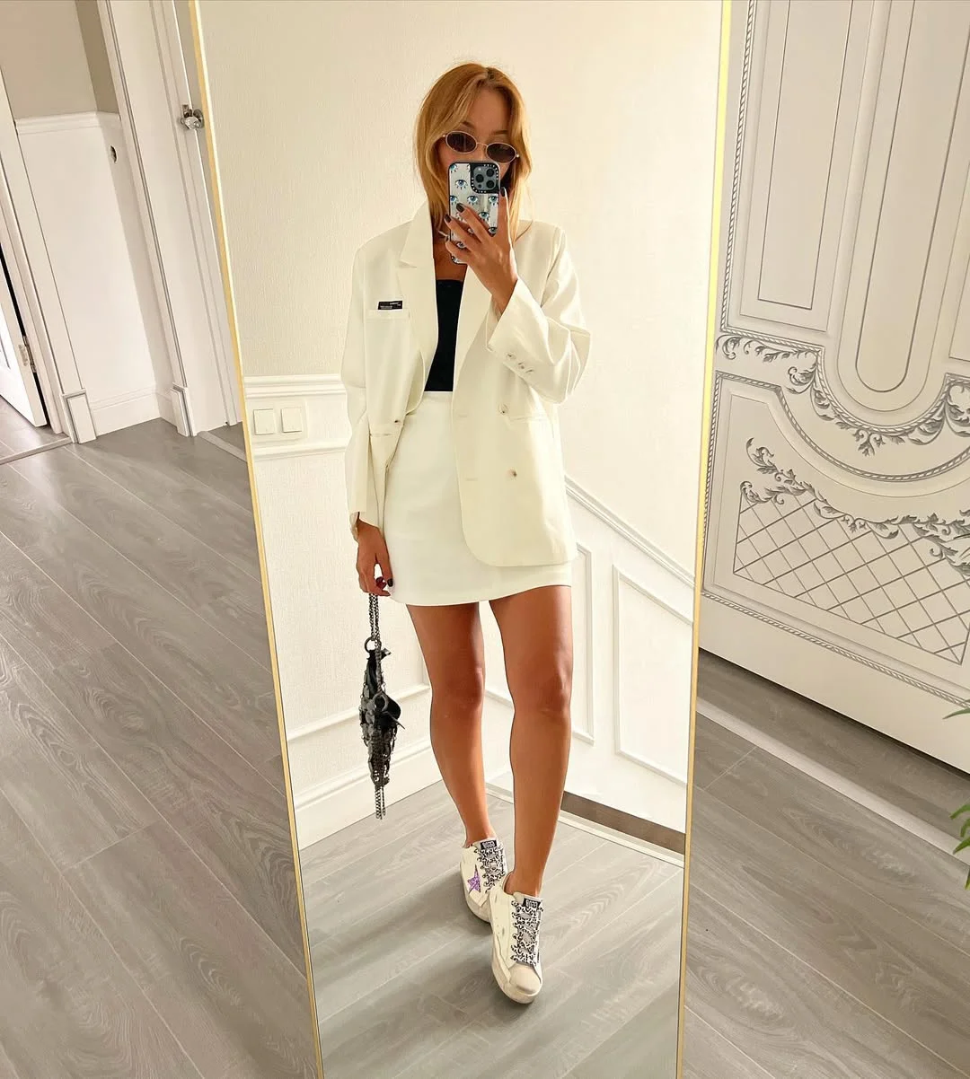 stylish fall skirt and sneakers outfits 2026 Crisp White Tailoring With a Black Mini and Sneakers