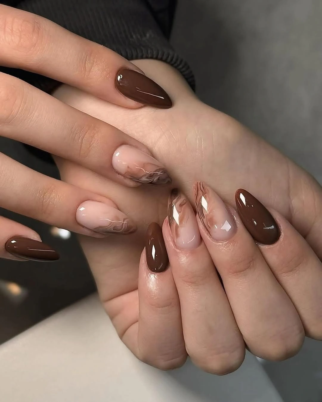chic fall almond nails 2026 Glossy Chocolate Almond Nails With Marble Accents