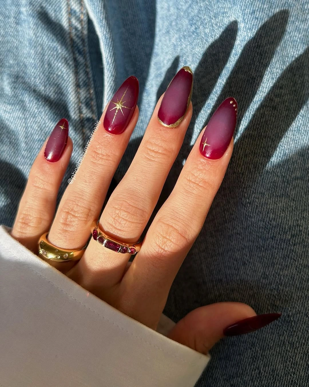 chic fall red nails 2026 Matte Burgundy Aura Nails With Delicate Gold Details