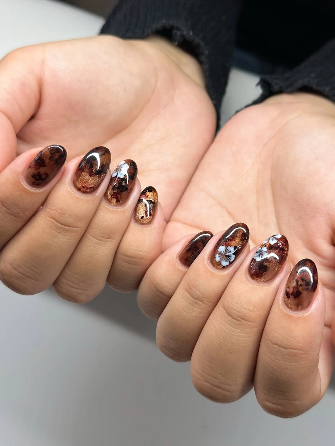 creative fall medium nail ideas 2026 Glossy Tortoiseshell Nails With Delicate White Blossoms