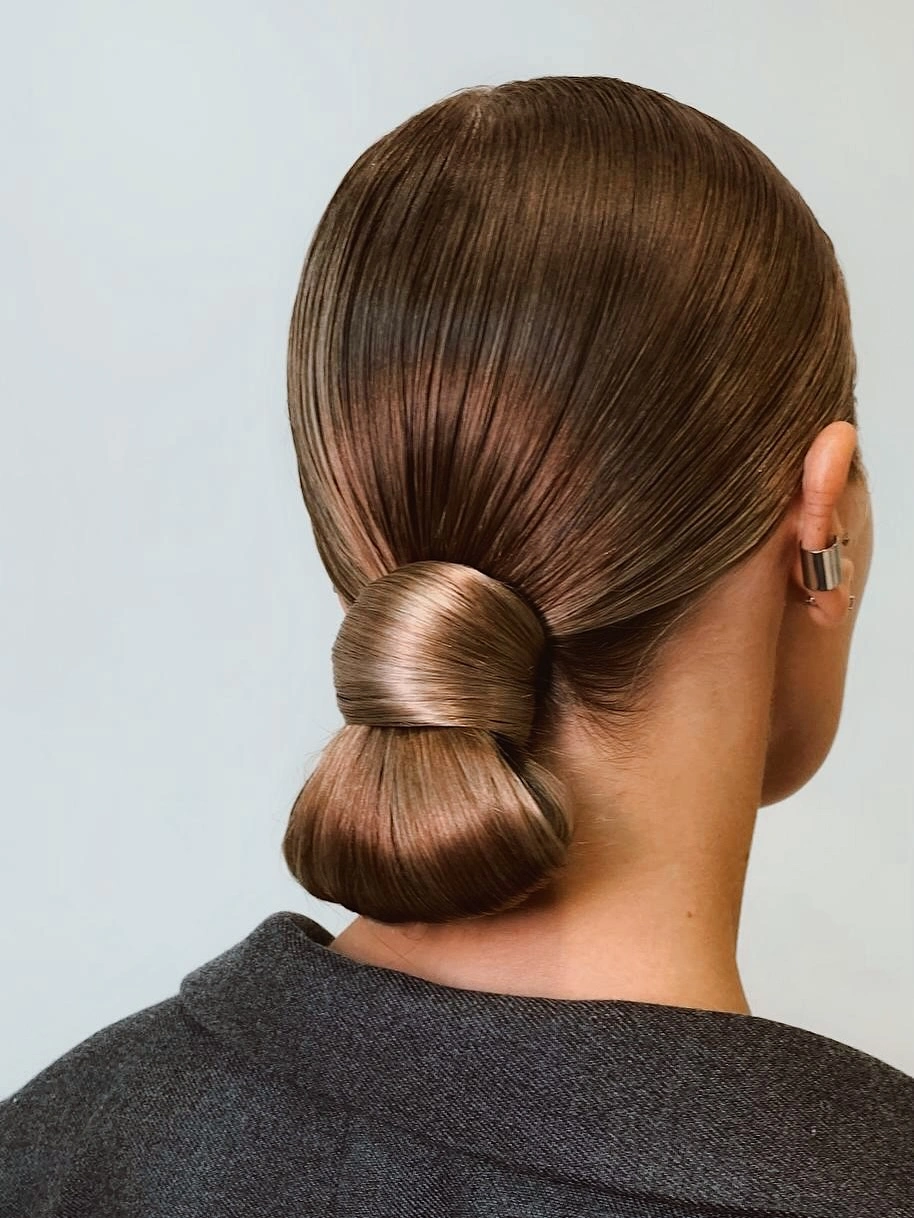 cute fall hairstyles for office 2026 Sleek Wrapped Low Bun For A Modern Office Look