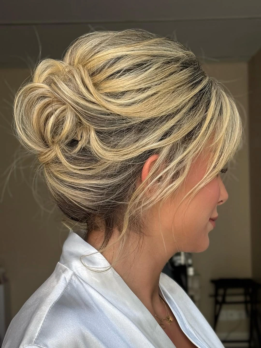 cute fall hairstyles for office 2026 Voluminous Twisted Bun With Soft Face Framing Layers