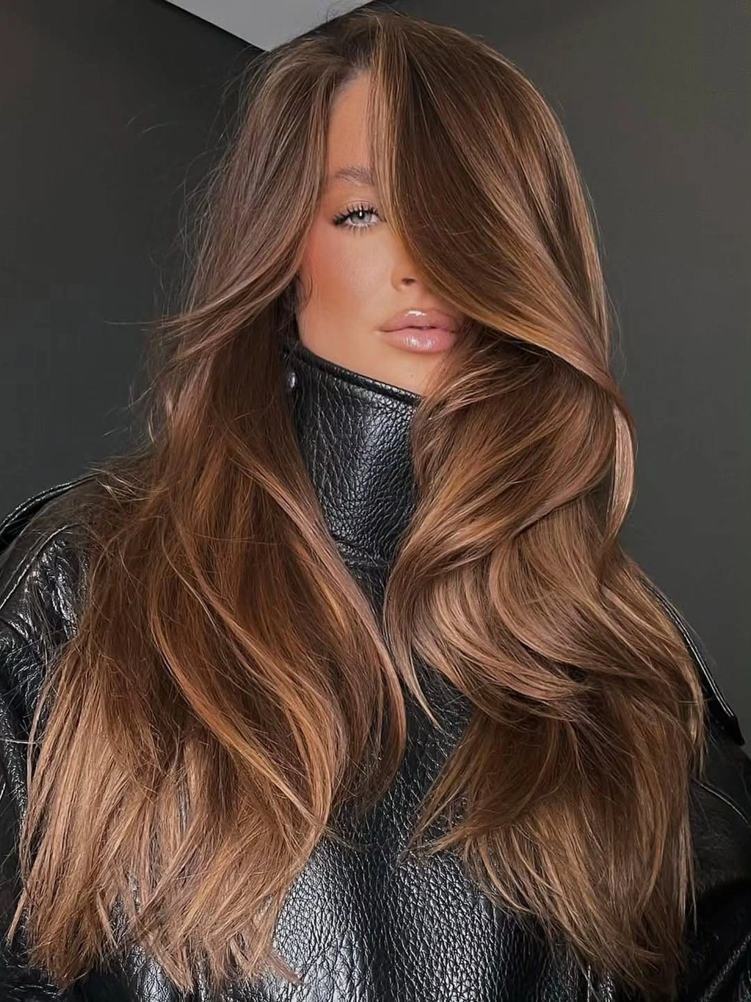 fall brunette hair colour 2026 Soft Cinnamon Balayage With Glamorous Curtain Layers