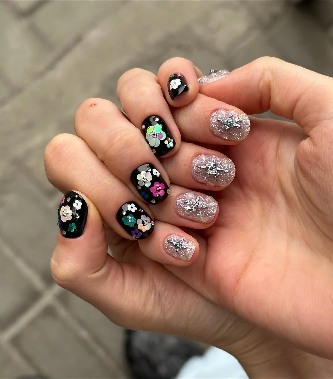 gorgeous fall manicure 2026 Black Floral Nails With Sparkling Accent Details