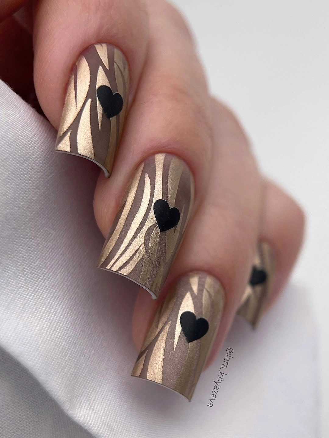 gorgeous fall manicure 2026 Golden Zebra Nails With Black Heart Accents