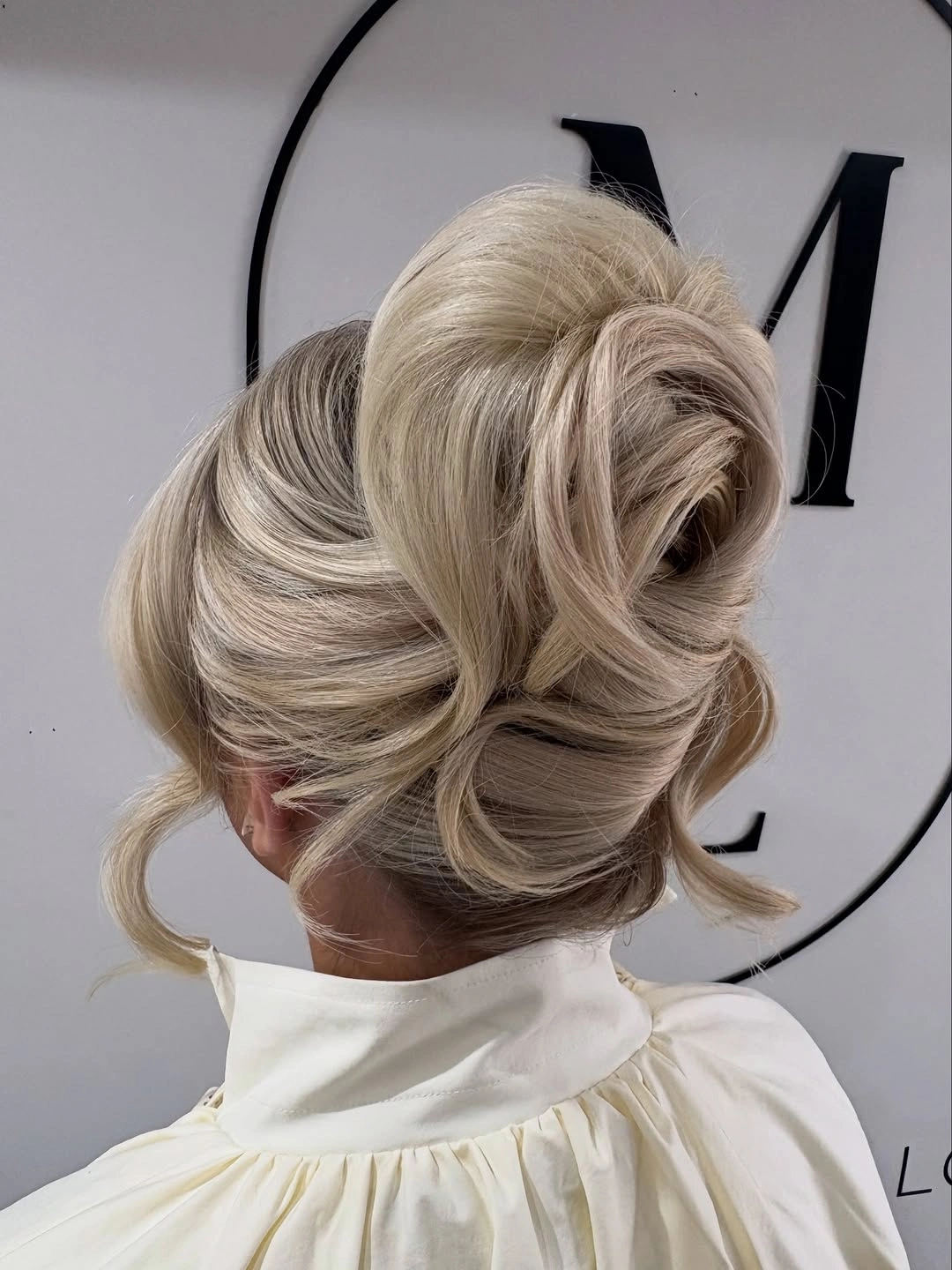 modern fall hairstyles for wedding guests 2026 Voluminous French Twist With Soft Face-Framing Pieces