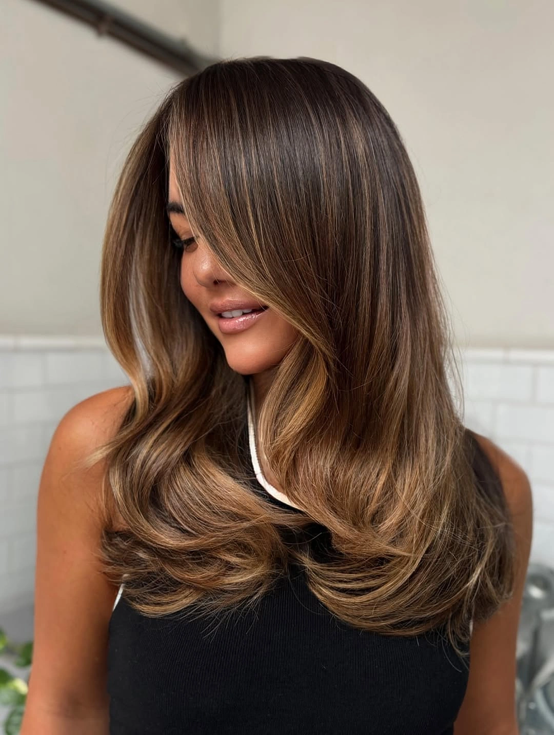 natural dimensional brunette hair color Warm Caramel Layers With Feathered Movement