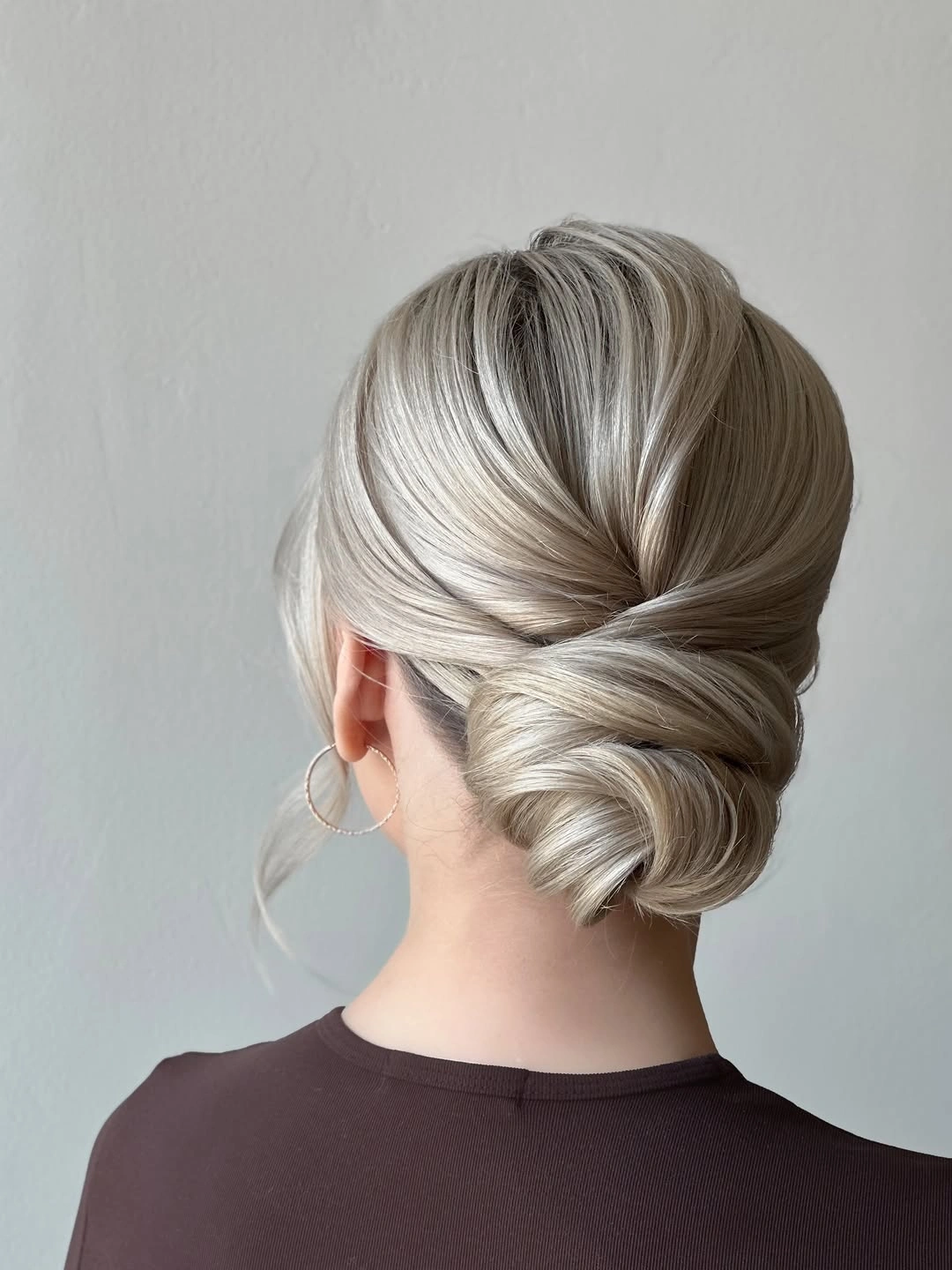 romantic bridesmaid hairstyling Low Chignon With Sleek Romantic Finish