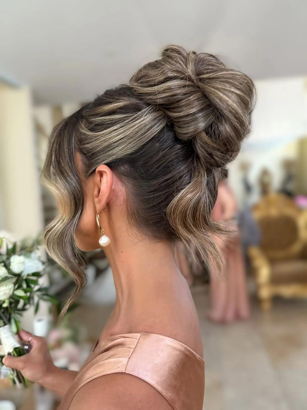 romantic bridesmaid hairstyling Textured Bridal Bun with Dimensional Highlights