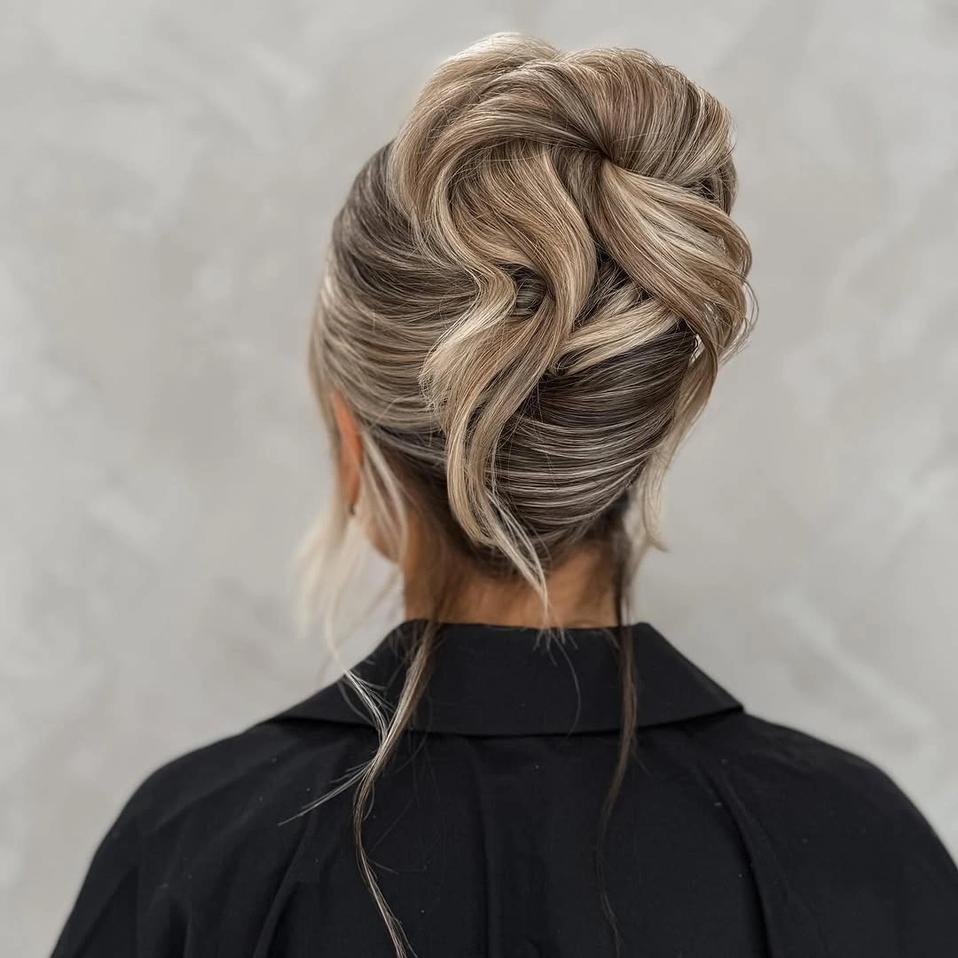 romantic bridesmaid hairstyling A Sculptural Twisted Bun with Lasting Elegance