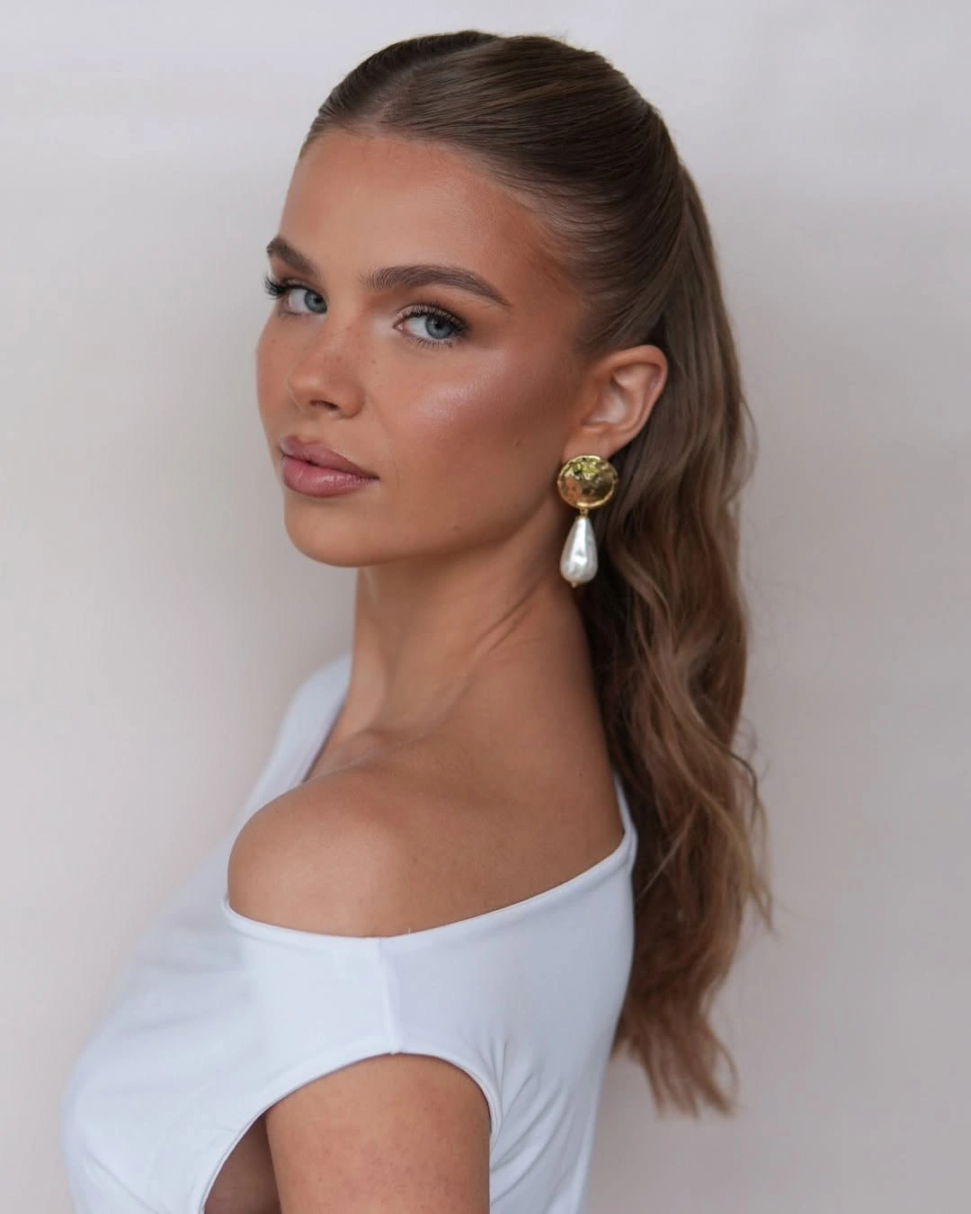 romantic bridesmaid hairstyling Classic High Ponytail with Soft Texture