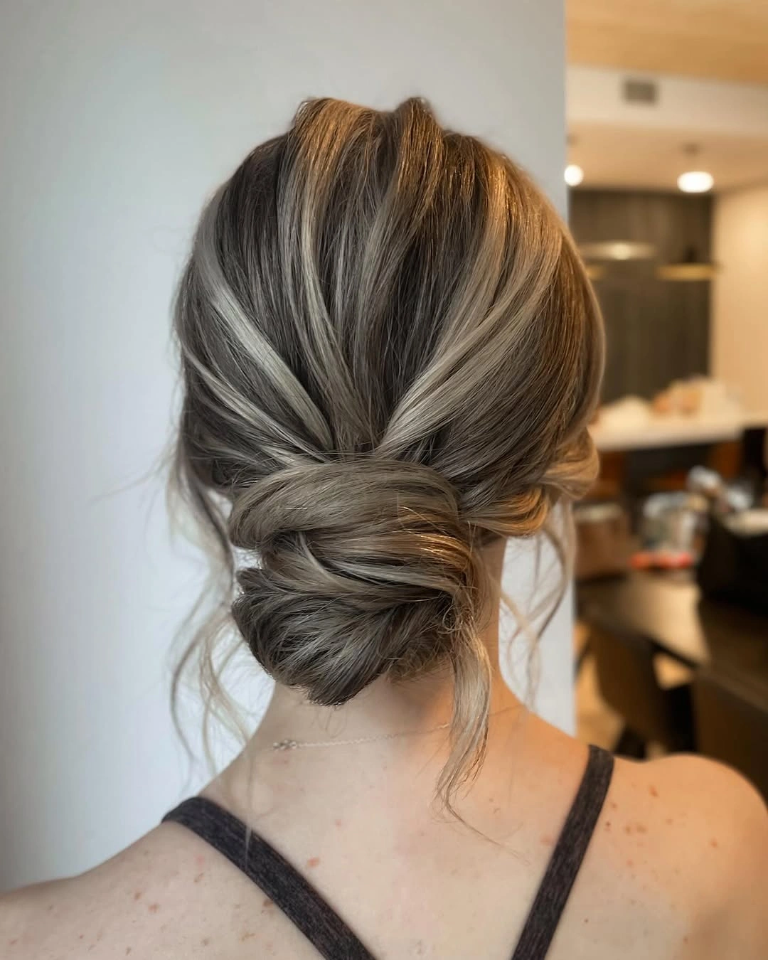 romantic bridesmaid hairstyling A Low Twisted Updo That Never Goes Out of Style