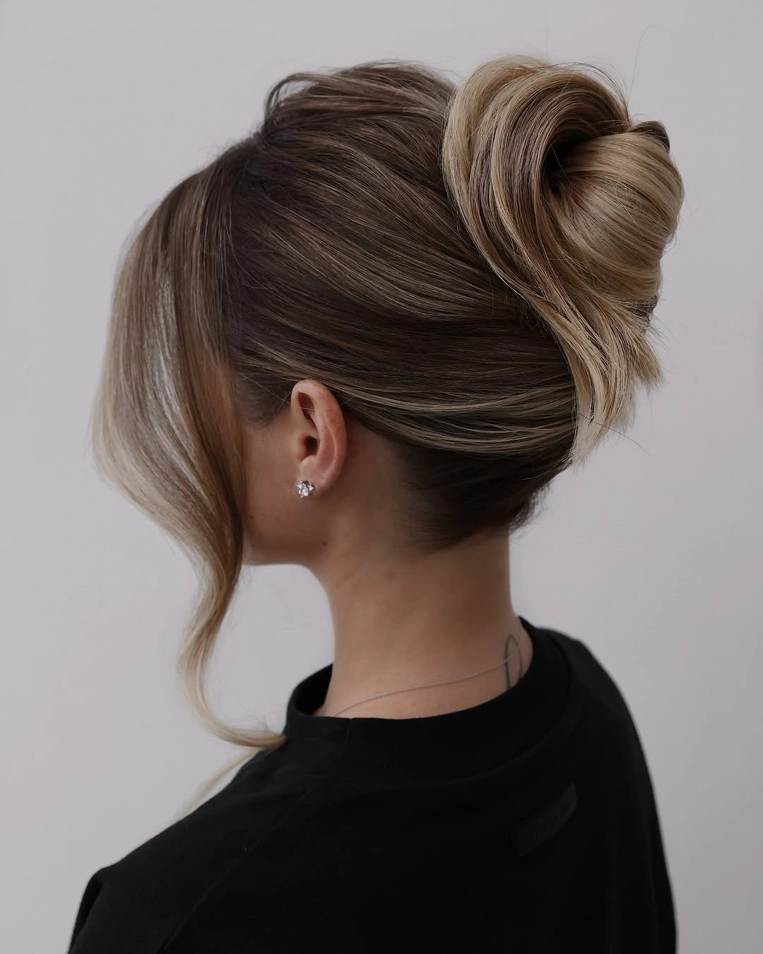 romantic bridesmaid hairstyling Elegant Twisted Bun With Soft Volume
