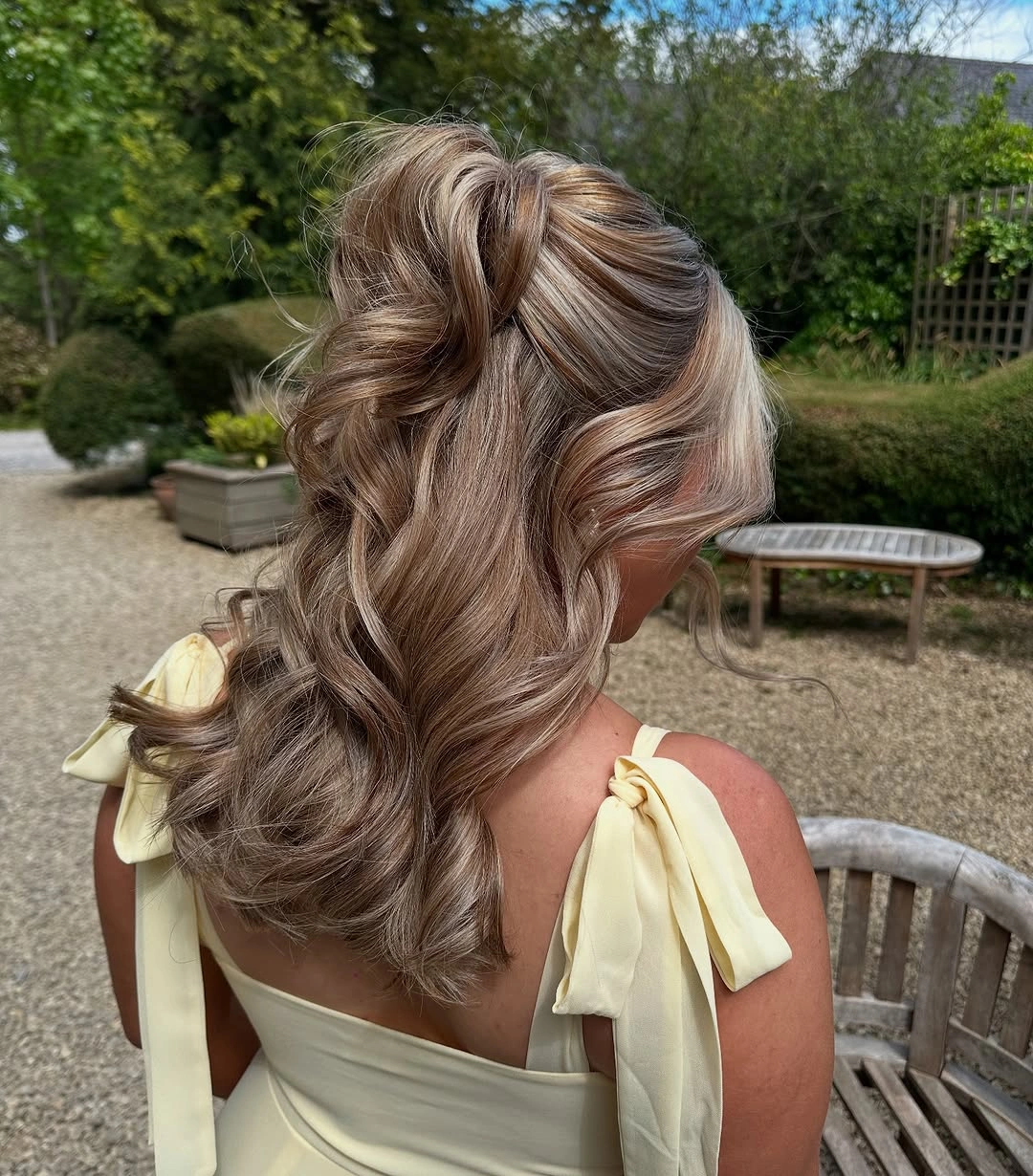 romantic bridesmaid hairstyling Flowing Waves With A Statement Twist