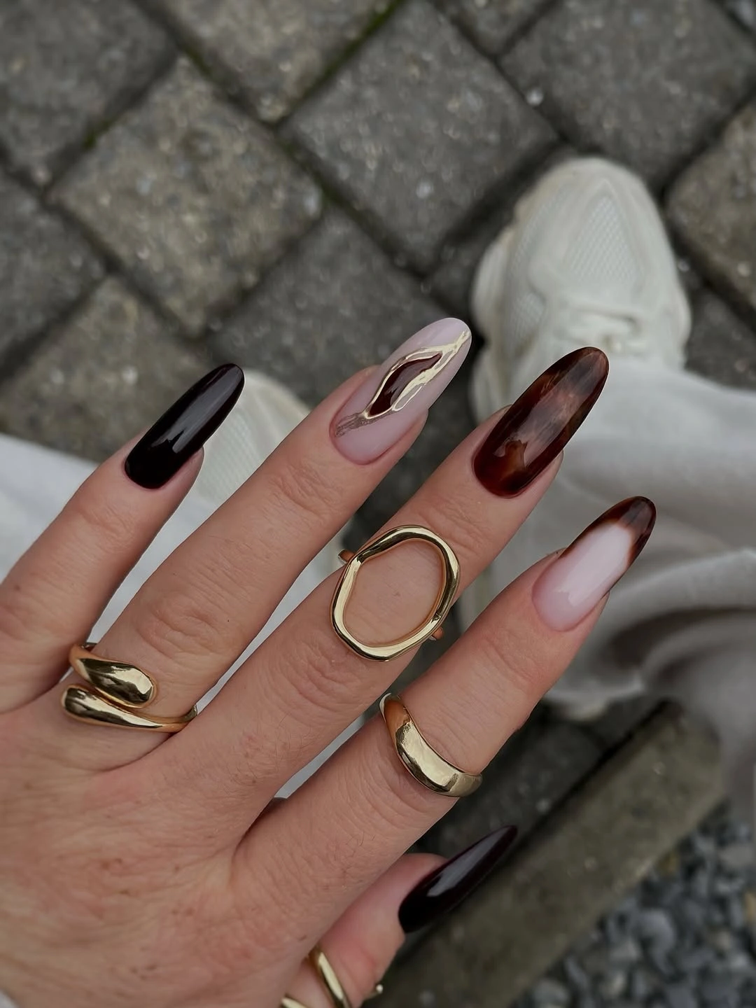 stylish fall acrylic nails 2026 Dark Brown Almond Nails with Modern Gold Details