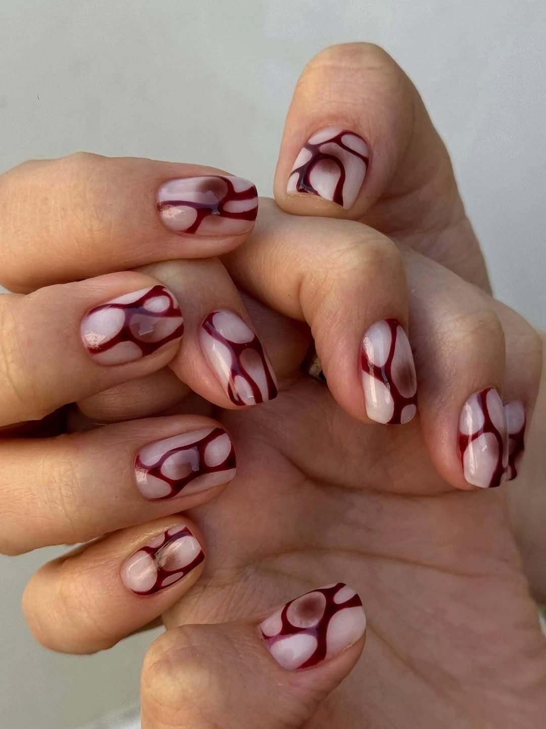 trendy fall nail designs for all skin tones 2026 Modern Burgundy Abstract Nails With Artistic Energy