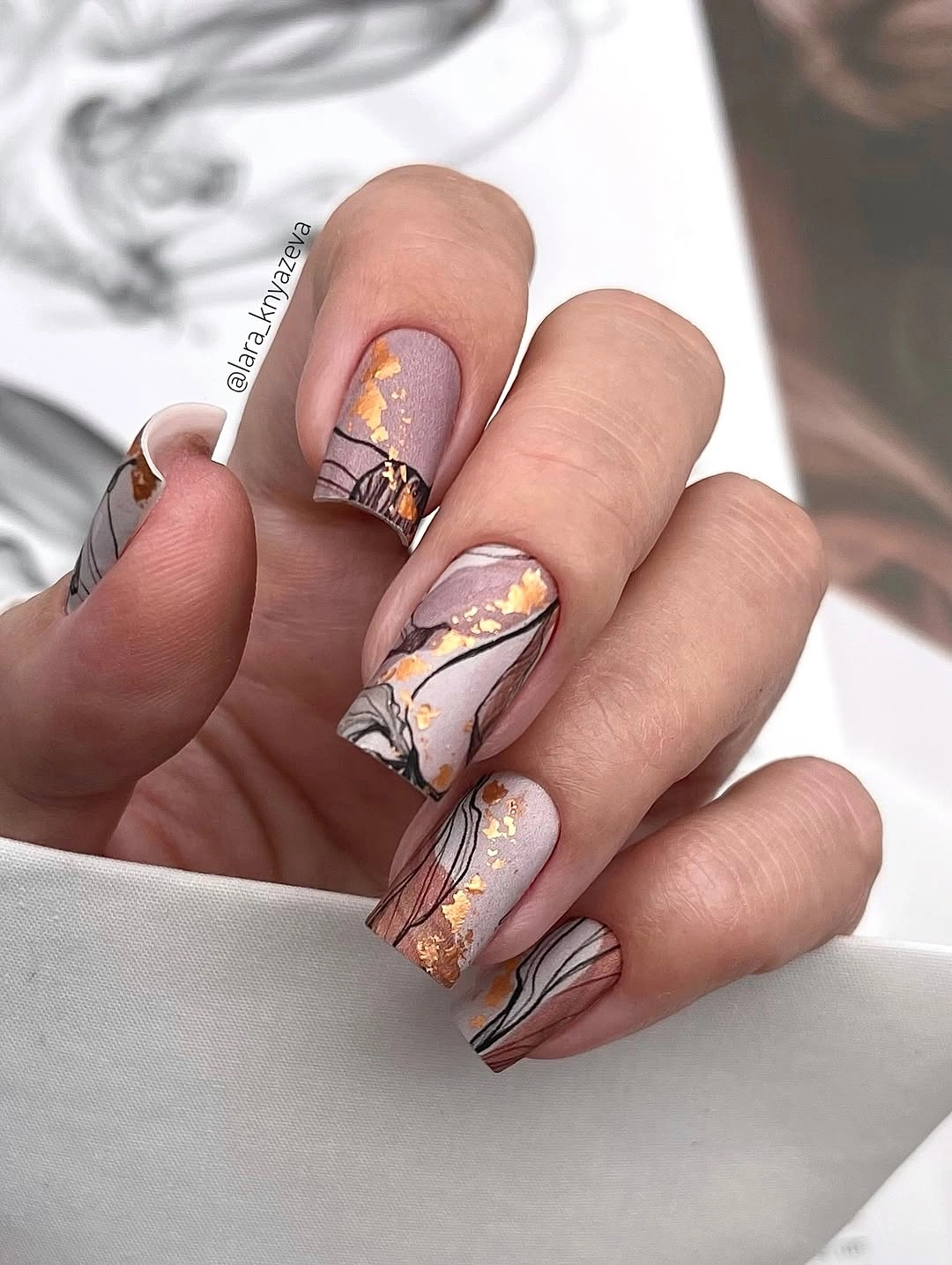 chic fall mid length nails 2026 Elegant Abstract Gold Foil Nails With Soft Neutral Tones