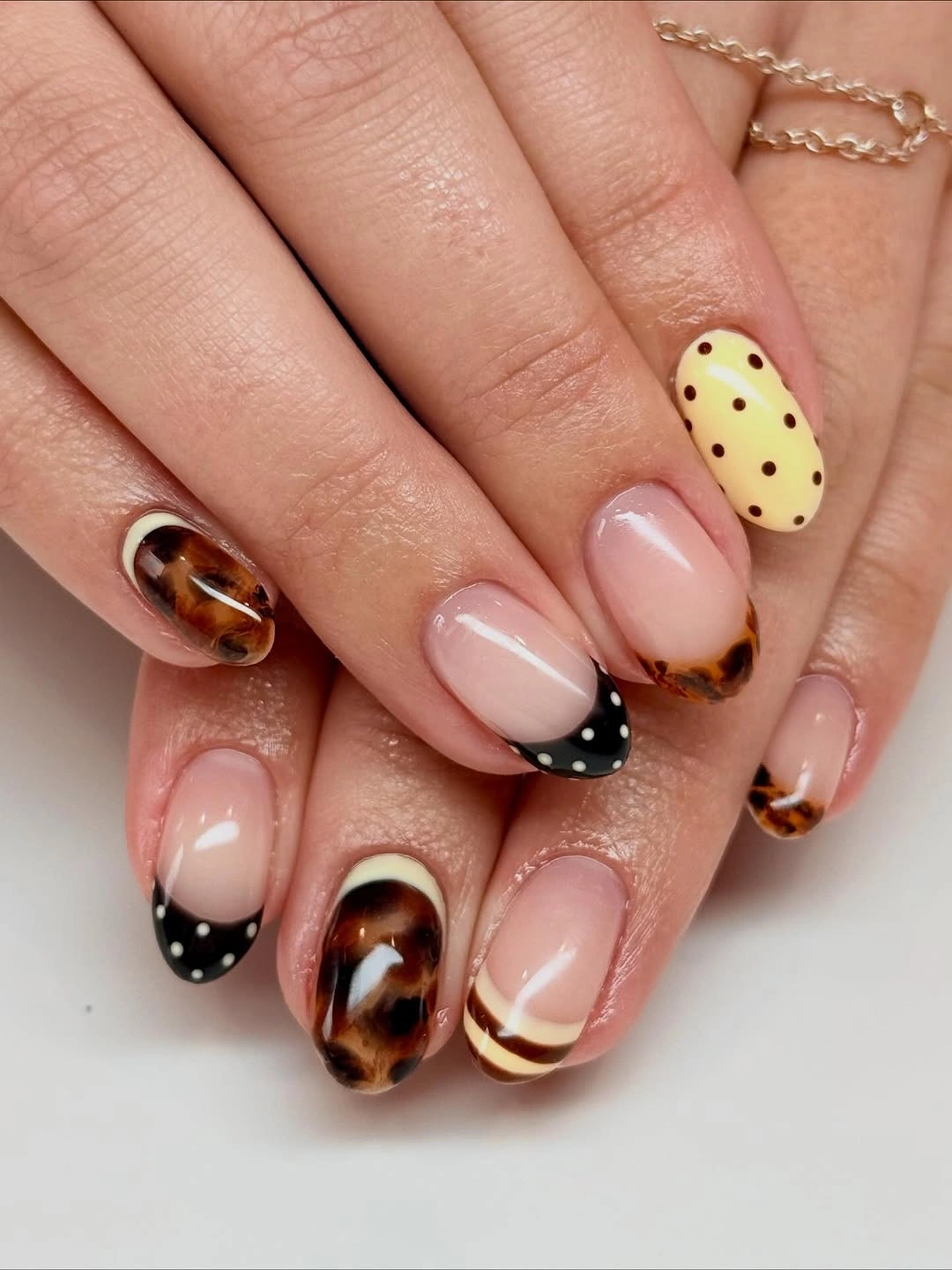 chic fall nail trends 2026 Playful Tortoiseshell With Polka Dot Details